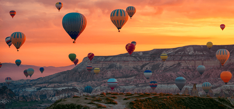 hot air balloons flying over the desert