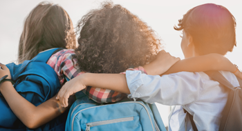 Children with backpacks on a school field trip