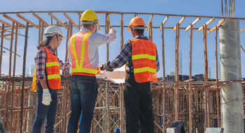 construction workers discussing project plans at a worksite