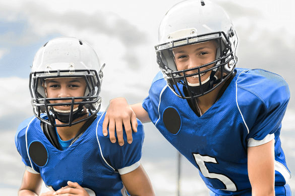 two kids in football helmets