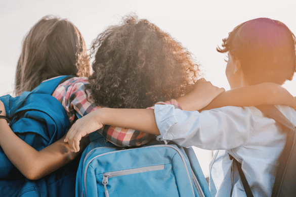 three children with backpacks