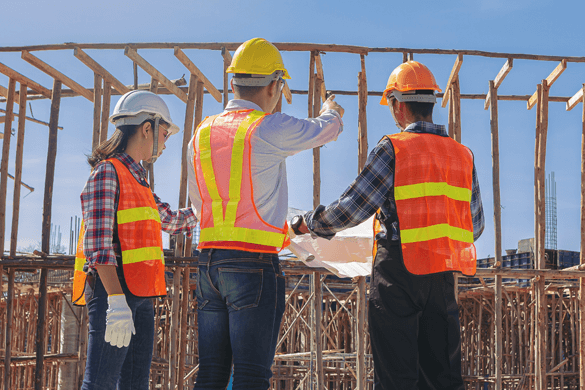 construction workers looking over a worksite